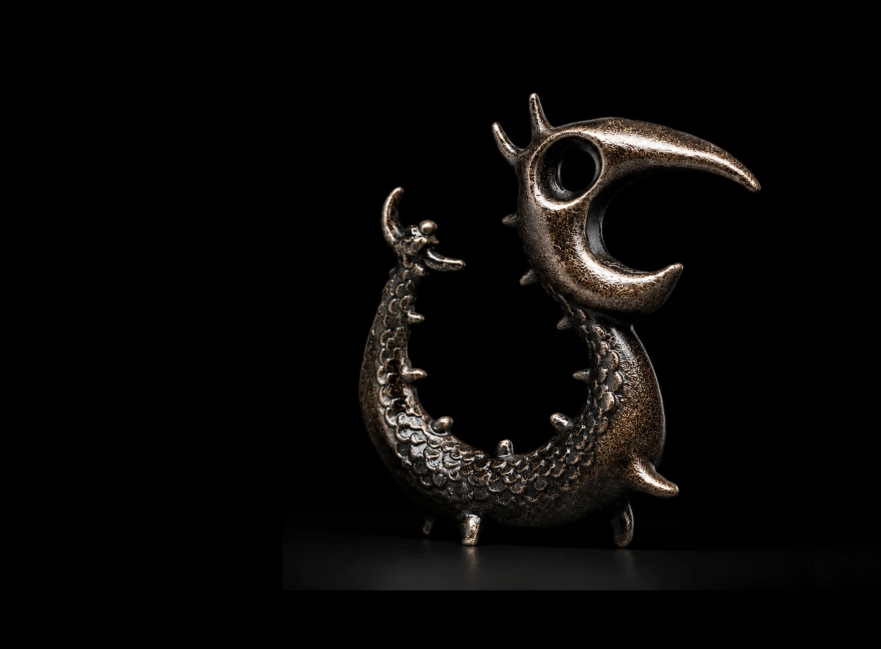 The cast-metal Dragon Opener standing against a black background.