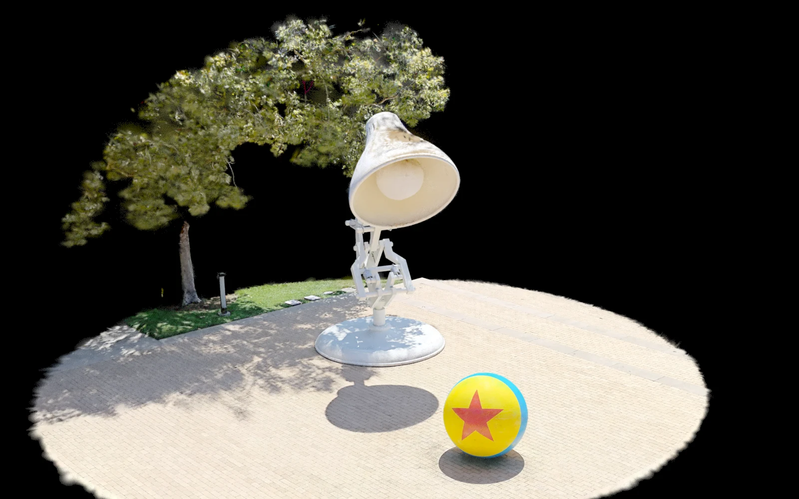 Isolated capture of the lamp, ball, trees and pavement.