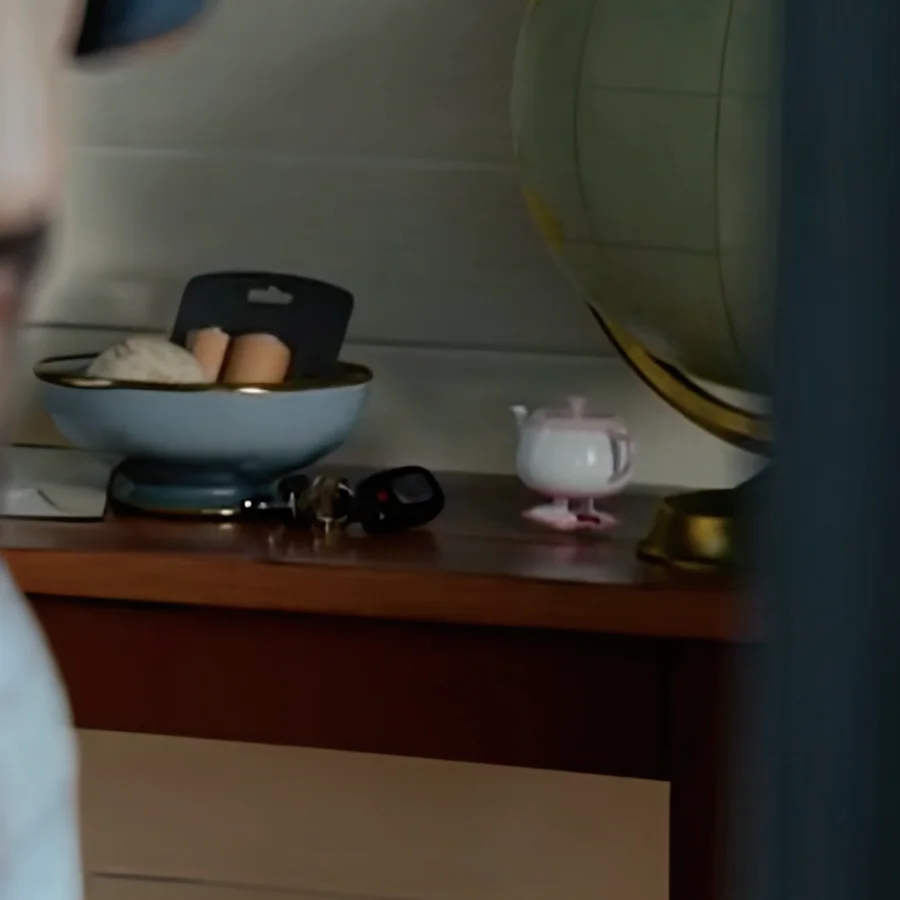 Close-up of the pink Walking Teapot beside a globe in Toy Story 5.