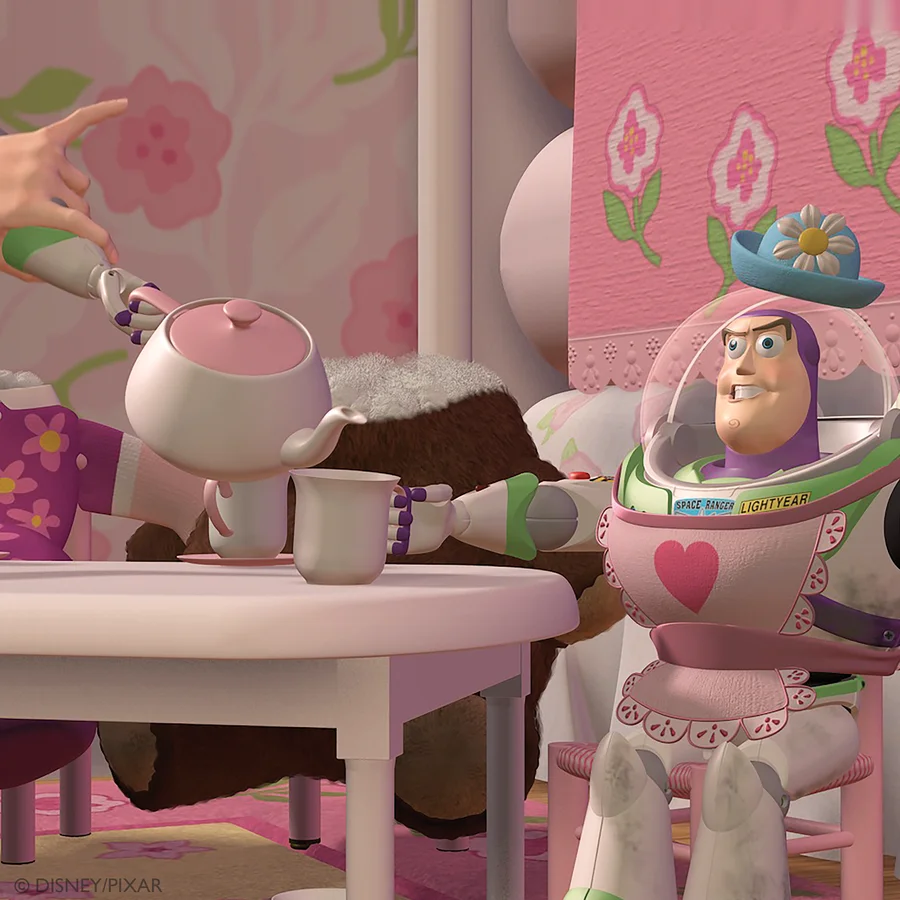 Buzz Lightyear wearing a pink apron at Mrs. Nesbitt’s tea party, with the original pink teapot.