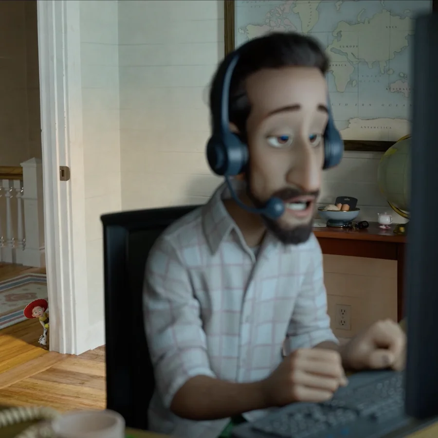 The Walking Teapot on a table behind a man wearing a headset in Toy Story 5.